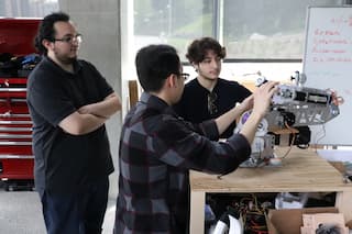 Photo of a student mentor working with the engineering team